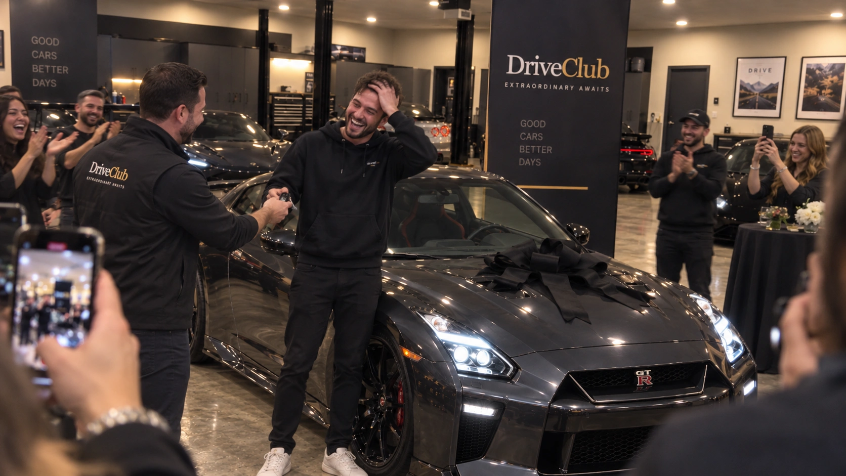 A man receiving a car key beside a Nissan GT-R as guests applaud